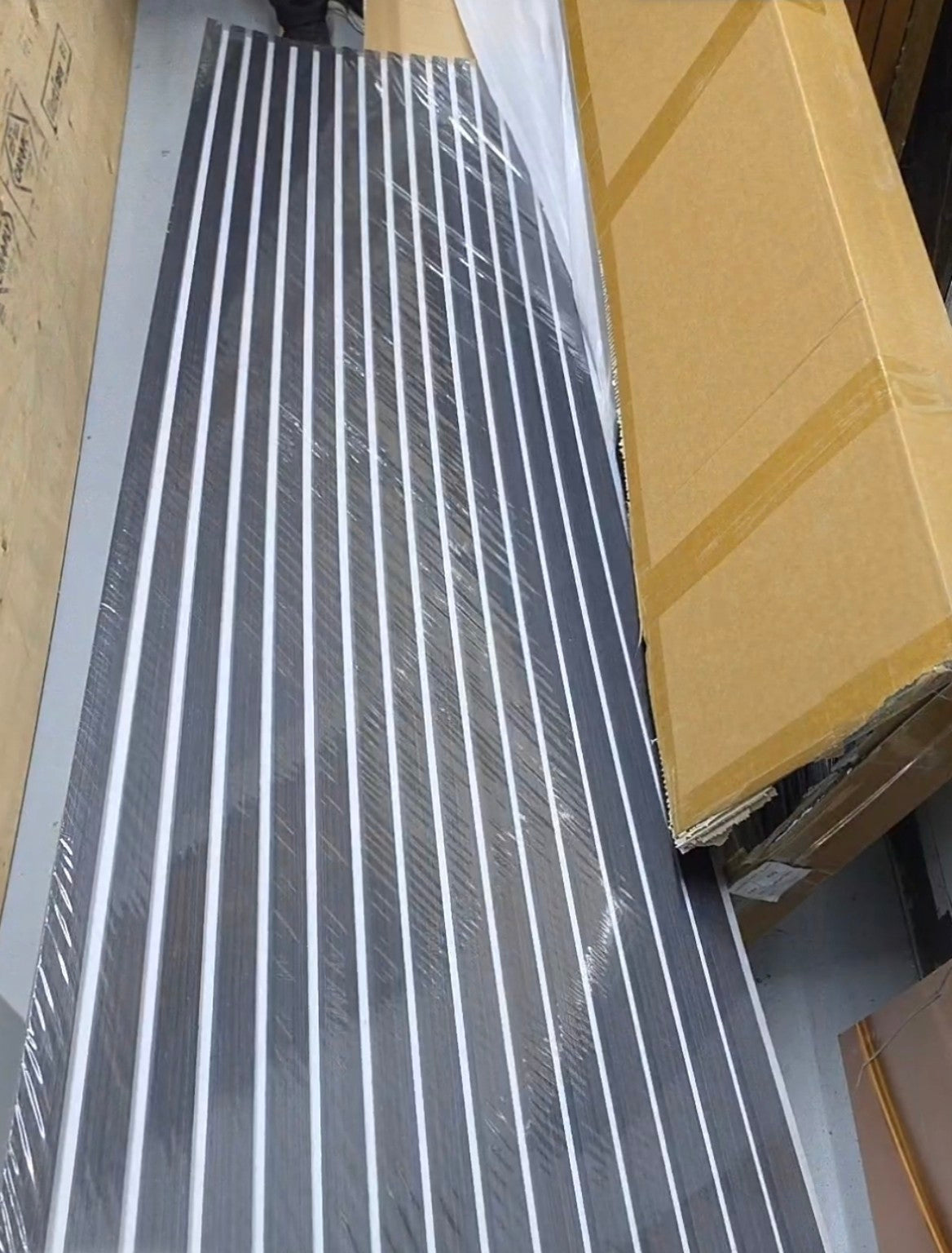 Original actual product photo showing charcoal black wood veneer slats and white felt backing